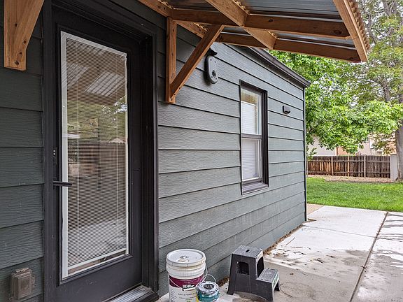 View at side patio, towards side/kitchen entry door and back yard.
