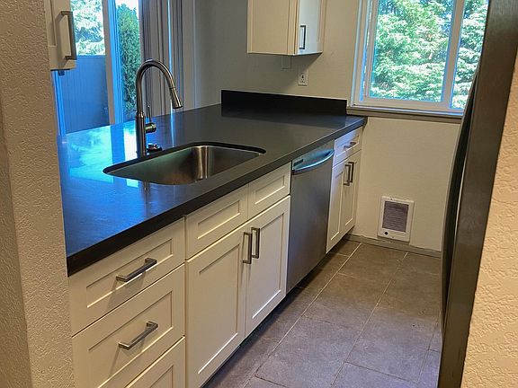 Kitchen with new cabinets, granite countertops and stainless steel appliances.