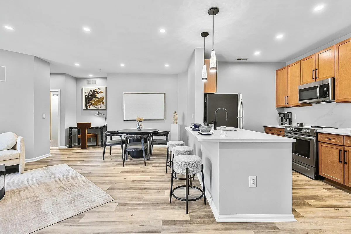 Experience stylish urban living with this beautifully designed open-concept kitchen and dining area. - Renaissance Plaza Square