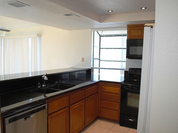 Kitchen with granite counter and garden window