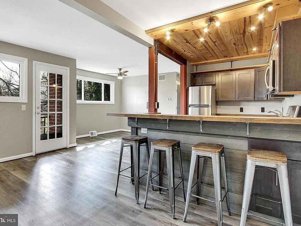View of main living space from front door; plenty of natural sunlight; door leading to spacious balcony