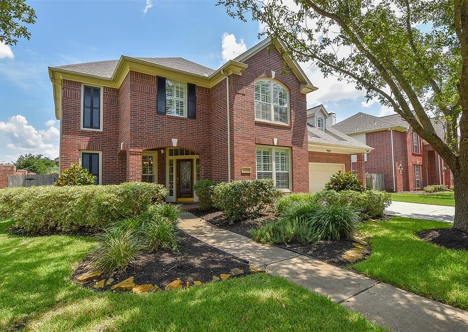 Located on the corner! Beautiful gardens surround this all brick home.
