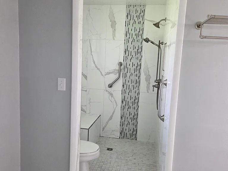 Walk-in shower looking from the primary bedroom