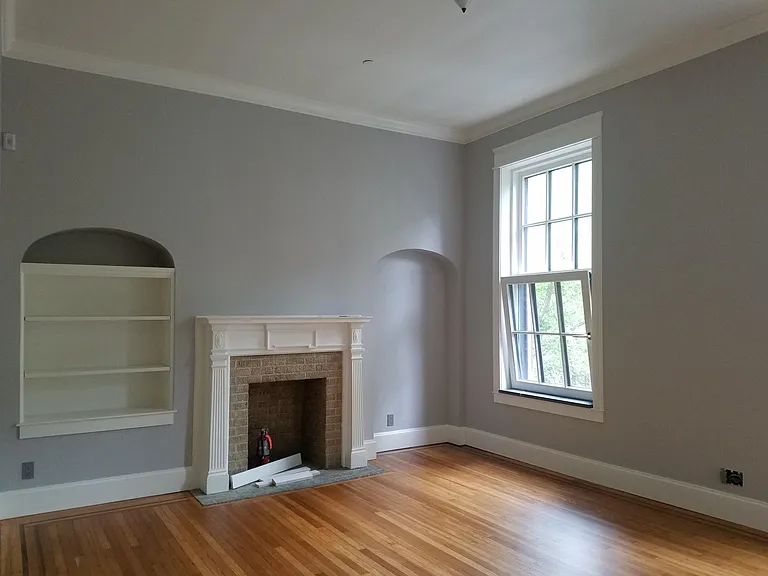 Master Bedroom with decorative fireplace. Fully sprinkled building. newly refinished hardwood floors. Beautiful stone sills.