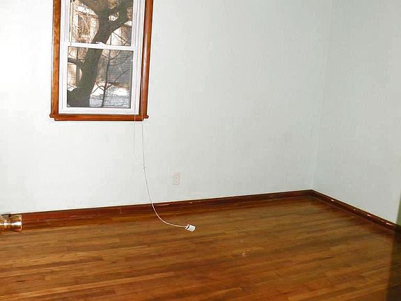 One main floor bedroom with hardwood flooring.