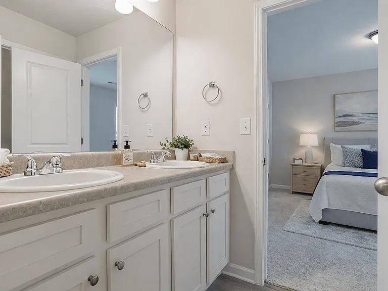 Secondary bathroom with double vanity and shower/tub combo