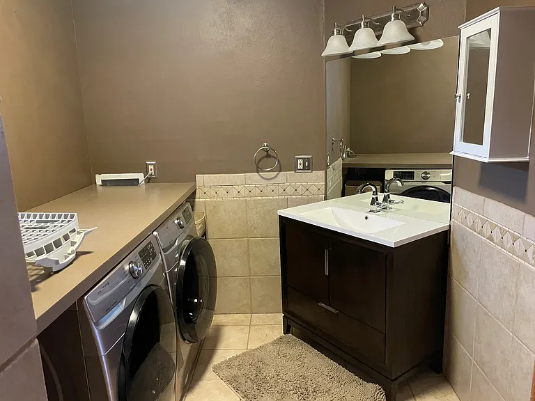Secondary bathroom with laundry.
