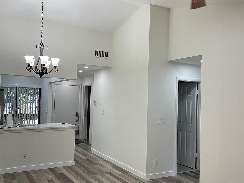 Loving Room to Front Door view.
New ceilings and flooring throughout.
Recessed lighting and Paddle Fan.