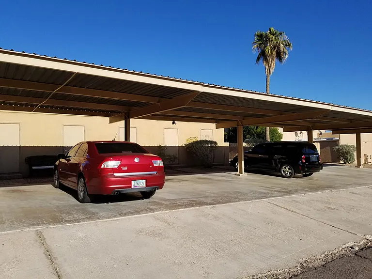 Overhead parking for two vehicles with storage doors pictured in front accommodating a very large storage area.