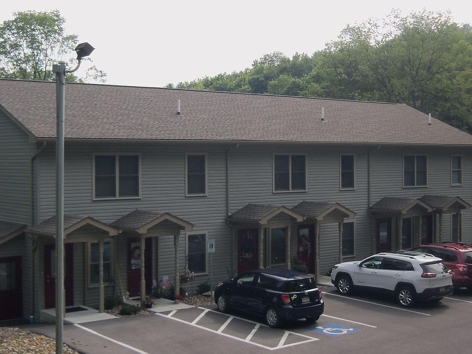 Front view of apartments on 975 West Long Avenue. Parking in front of each unit, guest or other parking behind. Lighted parking lot. Garage under each unit access from side stairway on either side.