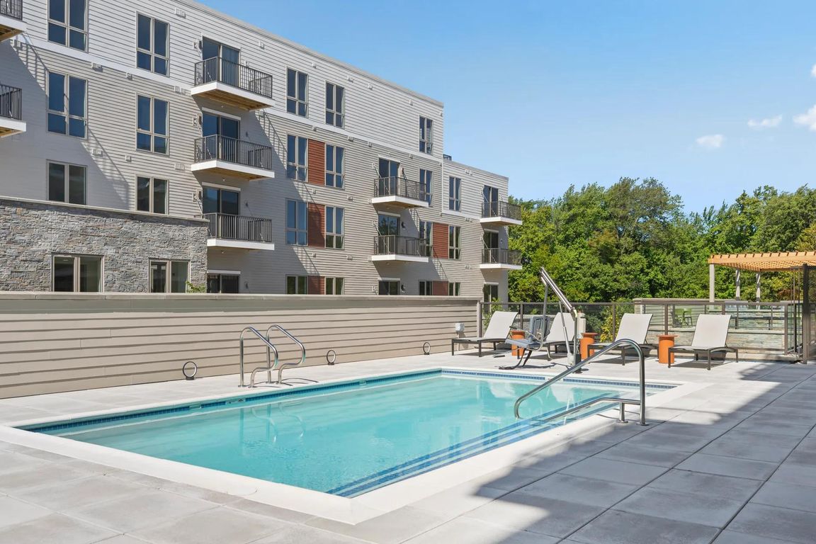 Resort-style pool with sundeck and chaise lounges.