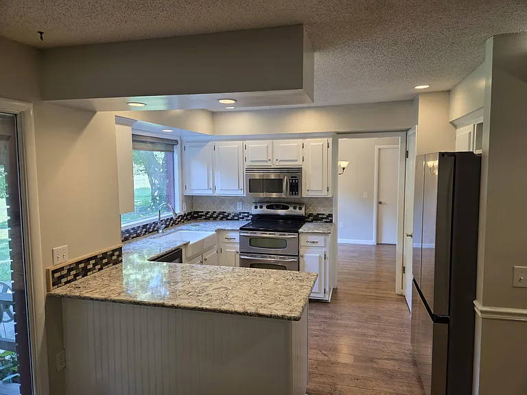 Kitchen as shown from the family room looking back towards the dining room on the back side