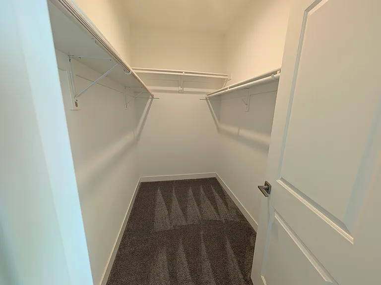 Primary bedroom walk-in closet