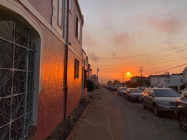 Outside looking at sunset over the ocean.