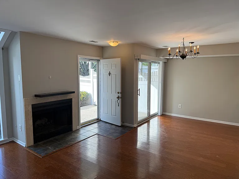Entry into living/dining area and wood burning fireplace
