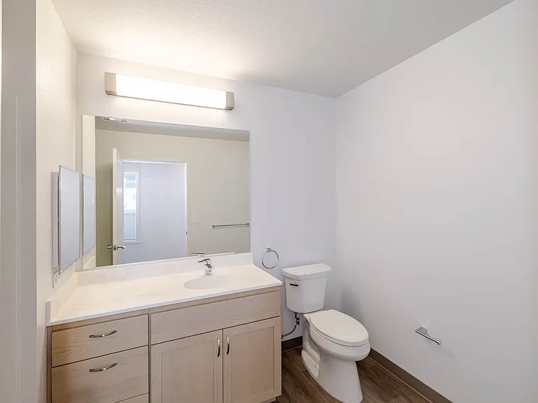 Bathroom B has ample lighting and a streamlined design.