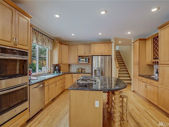 Gourmet kitchen boasts Solid 3 CM Slab Granite Counters and New GE Profile Stainless-Steel Appliances.  Double wall ovens, gas cooktop, Bosch dishwasher and French Doors refrigerator.  Now this is a Kitchen!