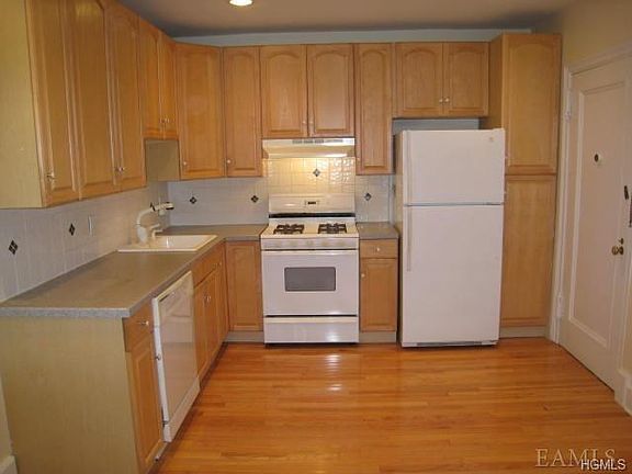 New Kitchen with Corian counters, dishwasher, range and refrigerator.