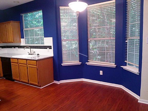 BREAKFAST NOOK LOOKS OVER THE RELAXING BACKYARD WITH GREAT TREES. SOLAR WINDOW SHADES ARE ON THE WIN