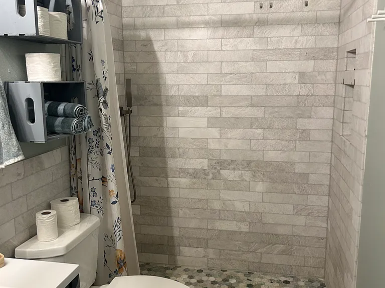 shared space downstairs: newly renovated hall bath with rain showerhead and handheld shower wand