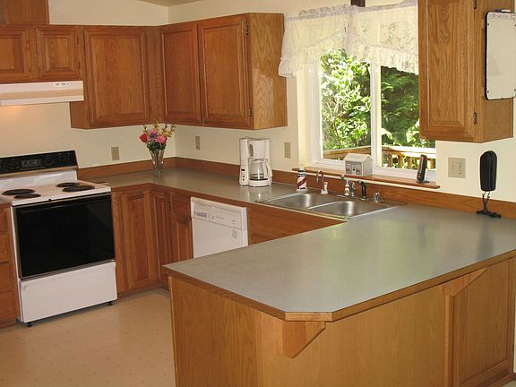 Open airy kitchen with generous cabinet package and pantry