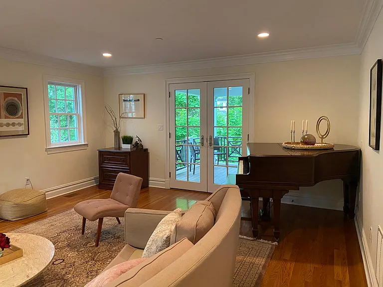 LR with French doors to back deck. Easy flow for entertaining. There is also decking at ground level in back yard.