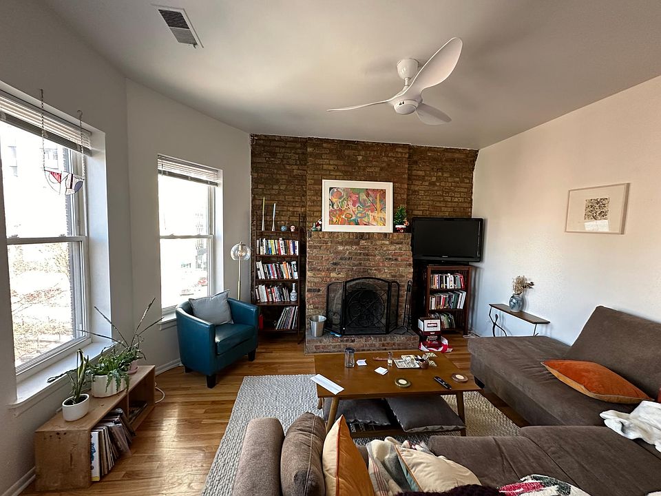 Living room looking East, wood-burning fireplace, modern ceilin fan/led lighting, insulated windows