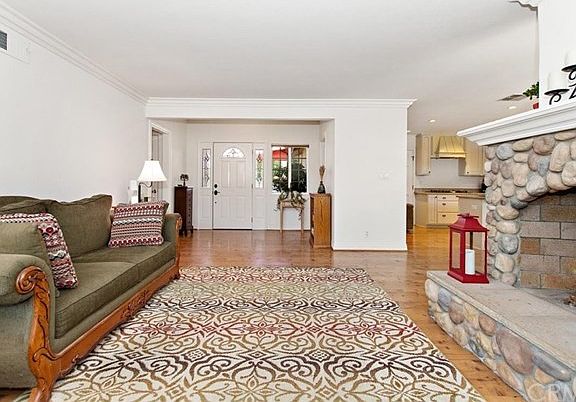 From living room, looking towards your front entry, kitchen to the right.