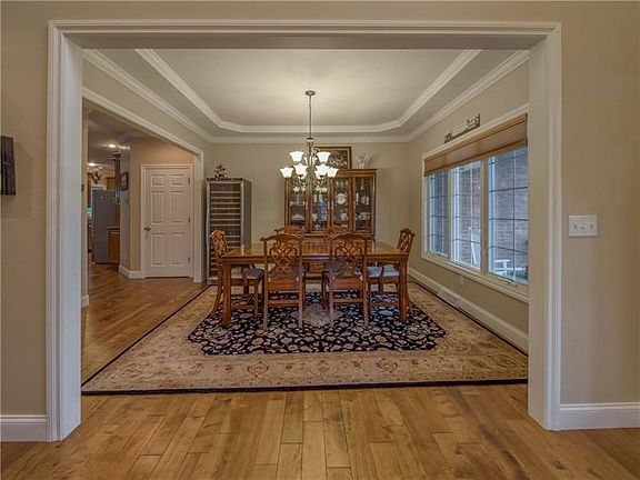 To the right is the elegant dining room with trey ceiling, bright windows and open to the kitchen.  Perfect for entertaining.