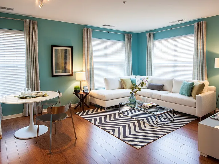 Bright and Expansive Living Room With Wood-Style Flooring (Available in Select Apartments)