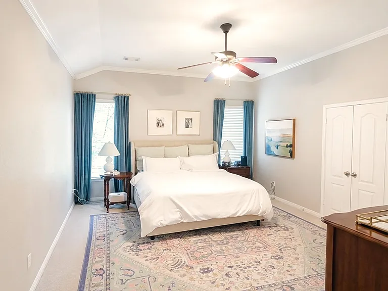 Spacious downstairs primary suite with vaulted ceiling
