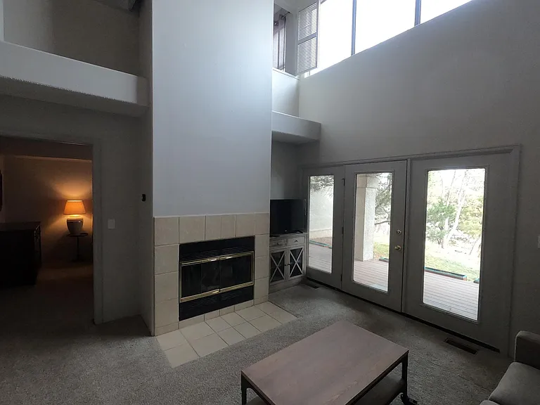 Living Room with Downstairs Bedroom and Deck access