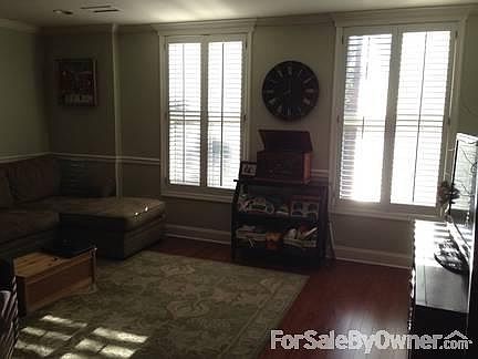 Living Room Alternate View
						:
						Large windows with plantation shutters; view from kitchen table