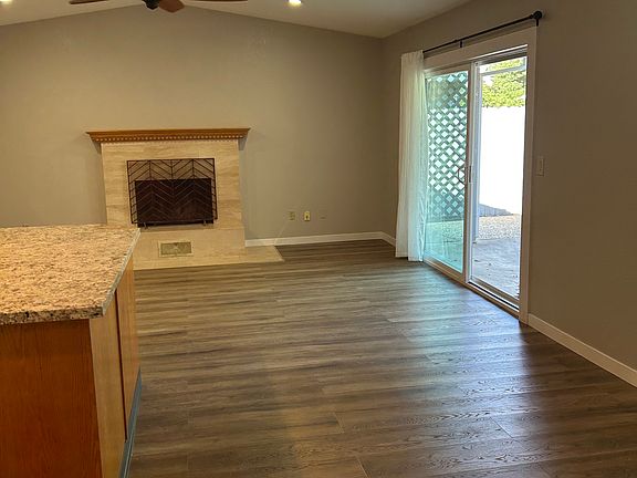 Family room with wood burning fireplace.