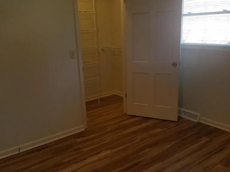 Large master with new flooring and walk-in closet.