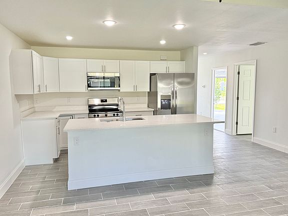 Spacious kitchen with all stainless steel appliances and full island.