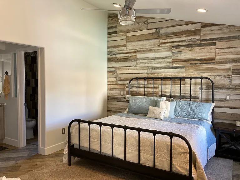 King Bed with full bath in primary room. Includes dresser, closet, desk and monitor