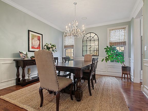 Large Dining Room with lots natural light and beautiful chair rail and moldings.