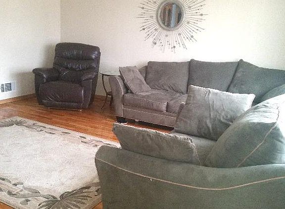 Large living room offers shining hardwood floor 