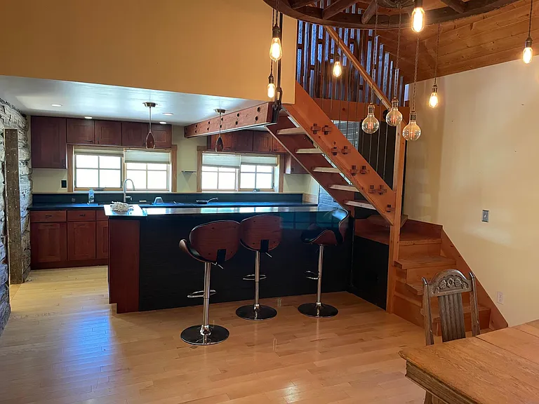 Kitchen with hand made wagon wheel chandelier.