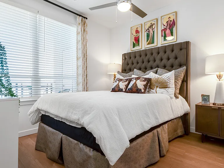 Bright Bedroom with Tufted Headboard and Large Windows for Natural Light
