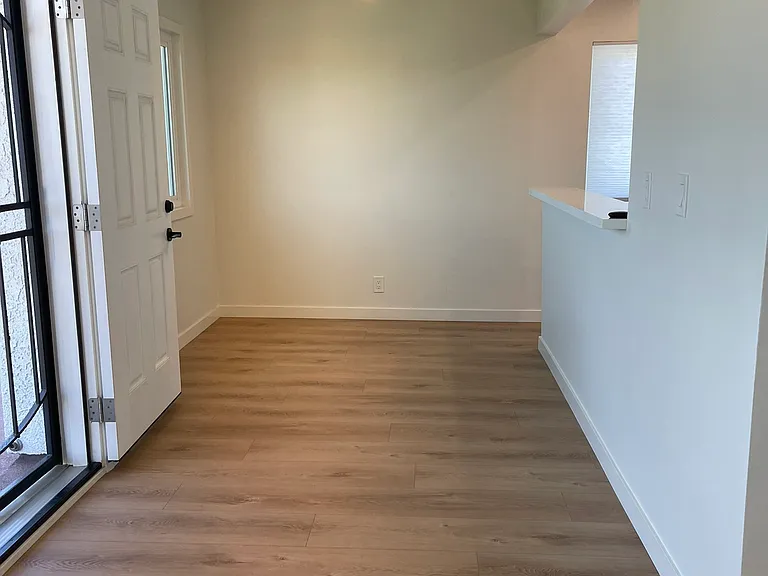 View from living room to dining room; kitchen to the right of dining room.
