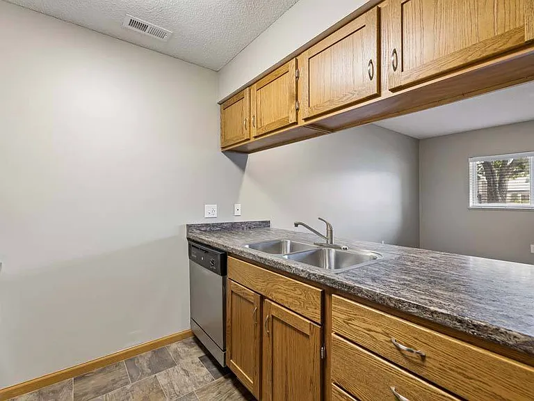 Classic cabinetry and a functional layout create a welcoming kitchen where meal prep, casual dining, and everyday moments come together with ease.