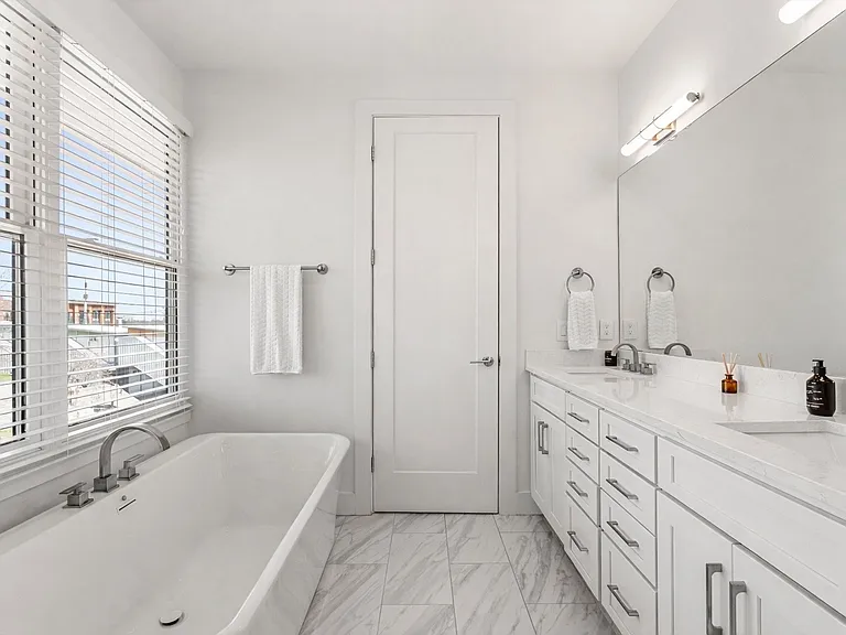 Relaxing soaking tub positioned beneath natural light.