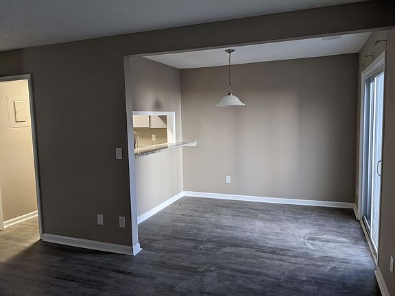 Dining area with service window from kitchen and granite countertop