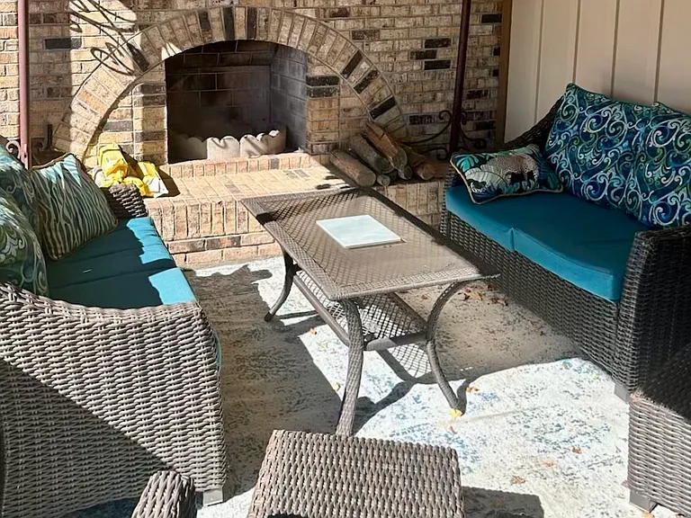 Covered patio with wood-burning fireplace