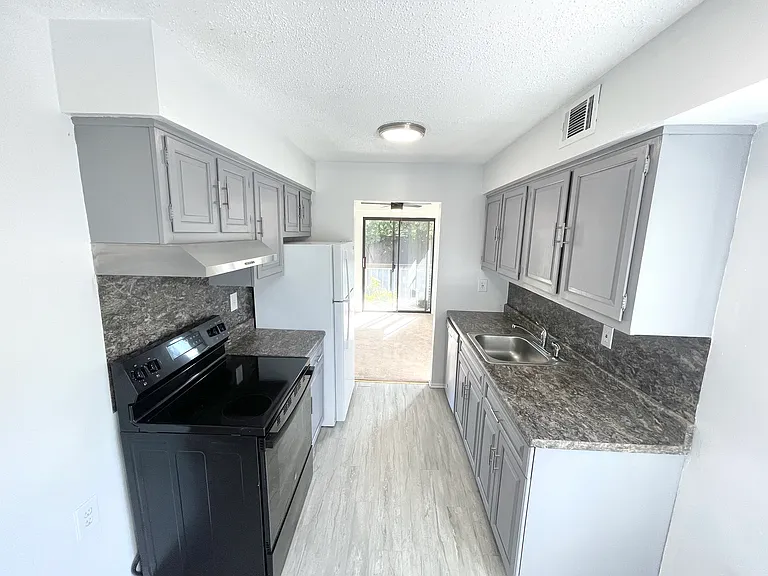Kitchen w/plank flooring - view into dining room w/private terrace
