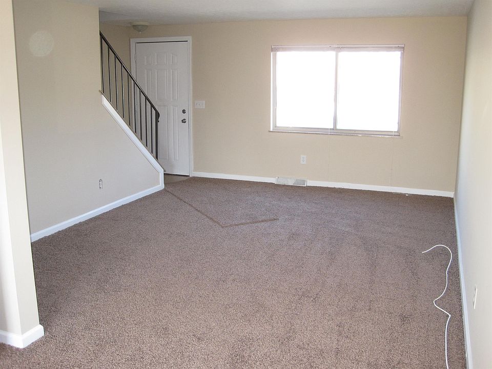 Spacious living room with brand new carpet.