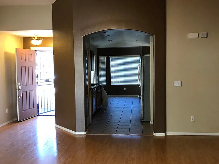 Living room looking into entry and kitchen