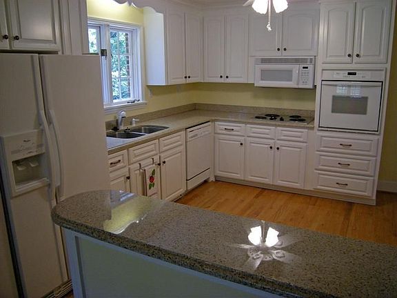 Kitchen open to dining room, living room and screened porch  